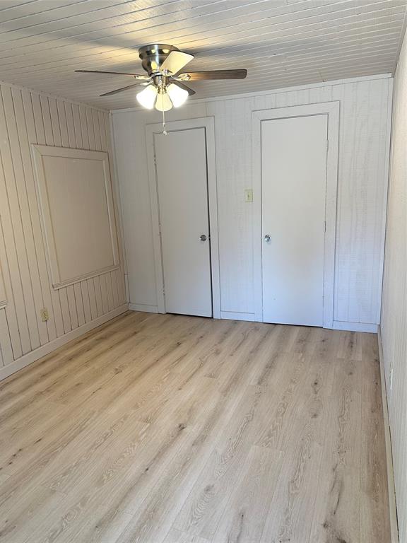2590 Rock Ridge Road Lucas, TX 75002 - Photo 11 of 25 Light wood-finish flooring complemented by white paneled walls and ceiling