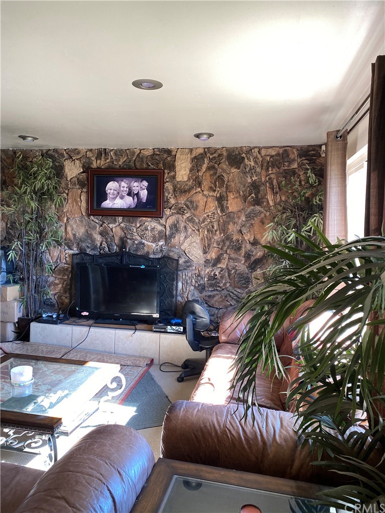 4684 Olive Street Montclair, CA 91763 - Photo 3 of 13 a living room with furniture and a flat screen tv