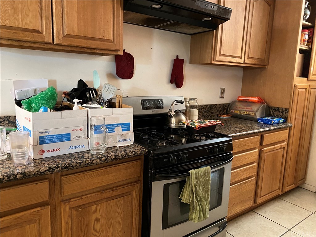 4684 Olive Street Montclair, CA 91763 - Photo 4 of 13 a kitchen with stainless steel appliances granite countertop a sink stove and cabinets