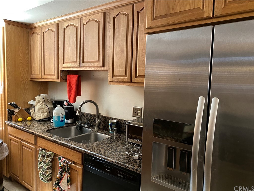4684 Olive Street Montclair, CA 91763 - Photo 5 of 13 a kitchen with stainless steel appliances granite countertop a refrigerator a sink a stove and cabinets