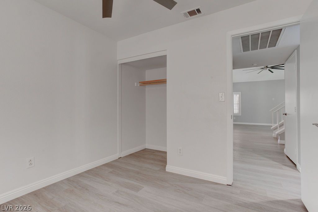 1416 Walstone Road North Las Vegas, NV 89031 - Photo 21 of 47 A well-lit bedroom provides ample storage with an open closet and fresh, neutral flooring.