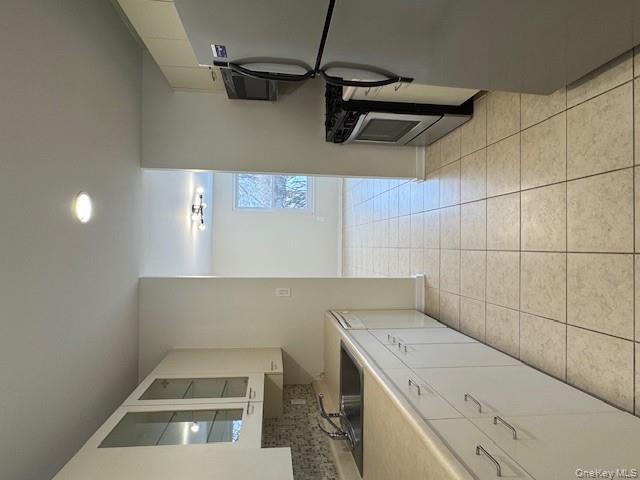 707 Lenox Road Monroe, NY 10950 - Photo 2 of 21 a large white kitchen with a sink and cabinets
