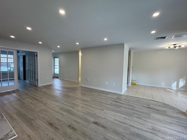 707 Lenox Road Monroe, NY 10950 - Photo 5 of 21 an empty room with wooden floor and windows