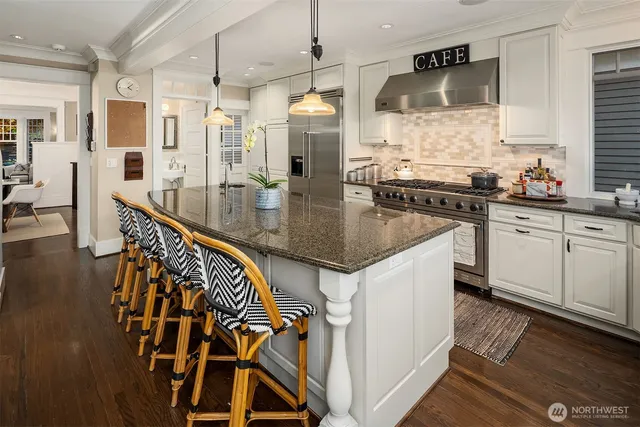 a kitchen with stainless steel appliances granite countertop a sink and cabinets
