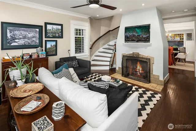 a living room with furniture a flat screen tv and a fireplace