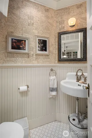 a bathroom with a toilet sink and mirror
