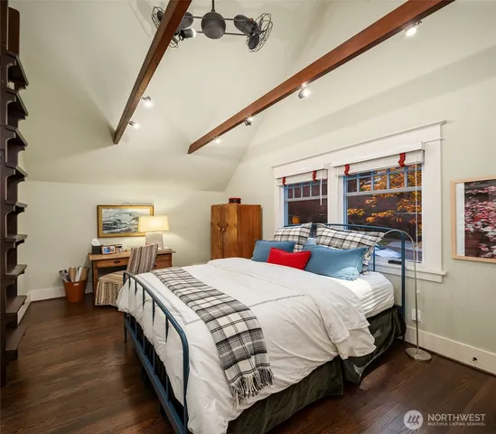 a bedroom with bed and large windows