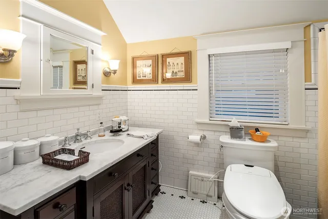 a bathroom with a sink toilet and mirror