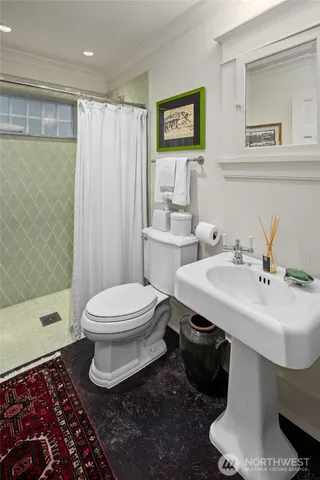 a bathroom with a sink toilet and shower