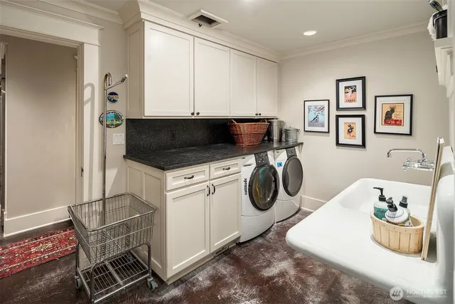a utility room with sink dryer and washer