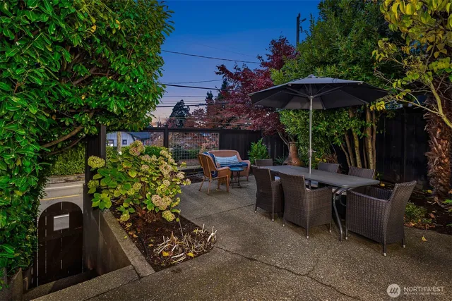 a view of a chairs and table in the back yard of the house