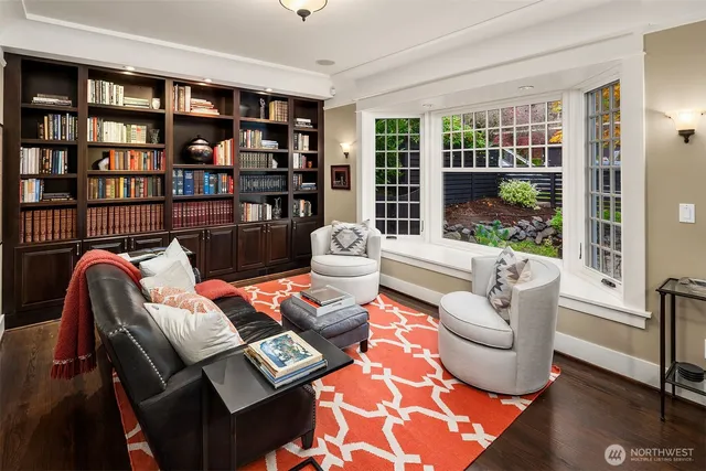 a living room with furniture and two large window