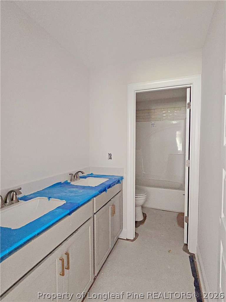 2678 Norrington Road Lillington, NC 27546 - Photo 22 of 31 a bathroom with a sink a toilet and a shower