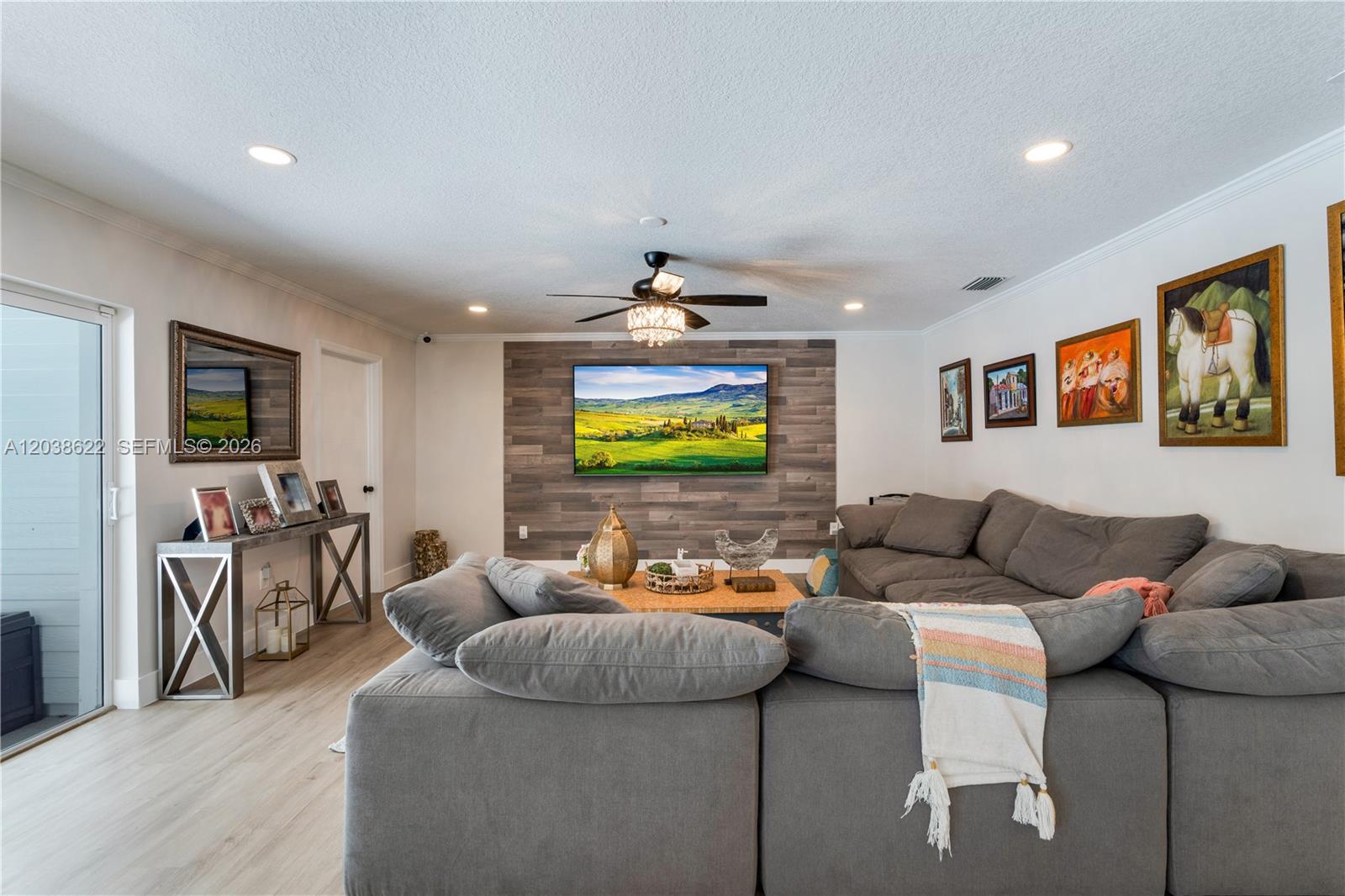 14830 Southwest 149th Street Miami, FL 33196 - Photo 10 of 43 a living room with furniture and a flat screen tv