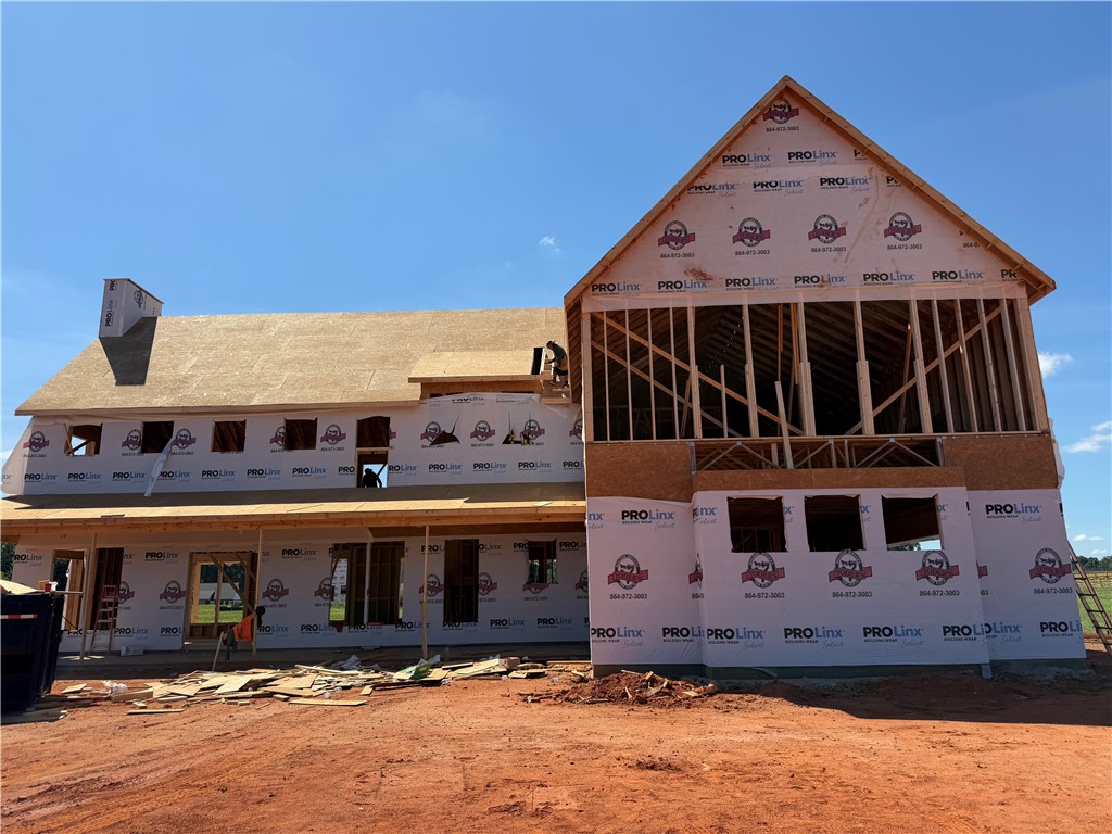 113 Dorchester Road Belton, SC 29627 - Photo 3 of 12 New residential construction takes shape under a clear blue sky.