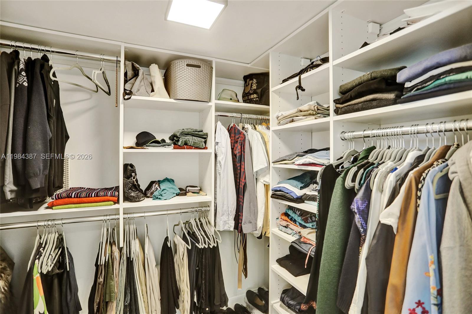 400 Alton Road, Unit 911 Miami Beach, FL 33139 - Photo 20 of 47 a view of walk in closet with clothes and shoes