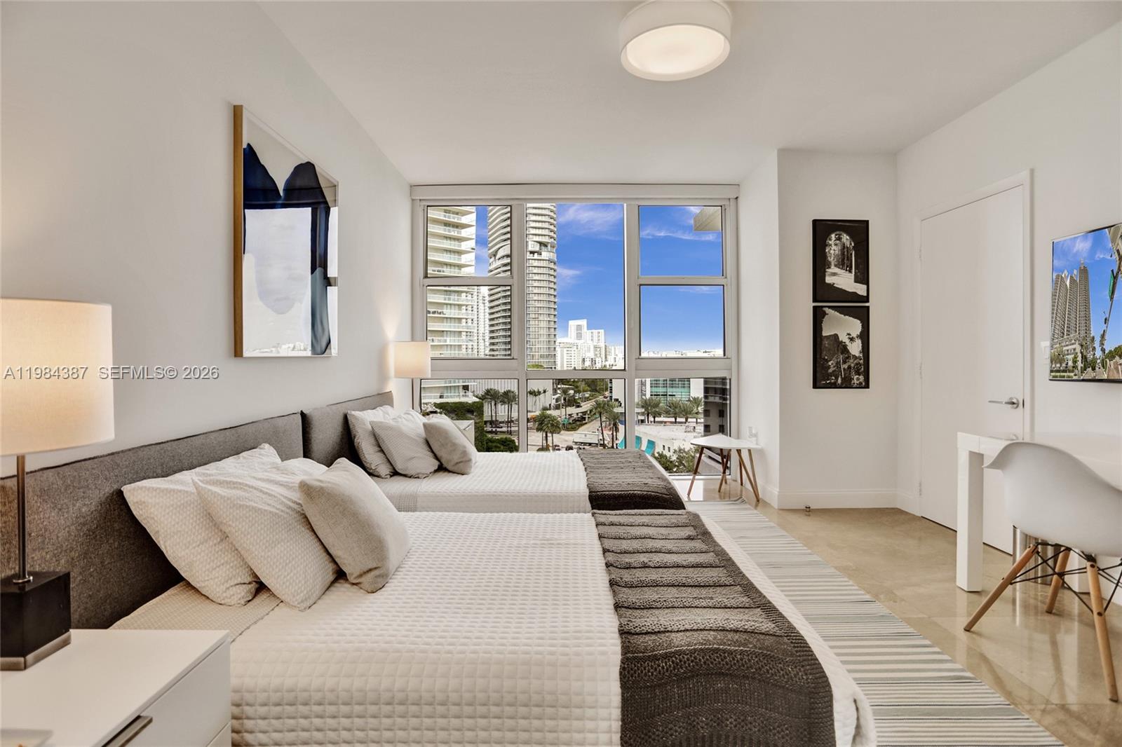 400 Alton Road, Unit 911 Miami Beach, FL 33139 - Photo 26 of 47 a bedroom with a large bed and a window