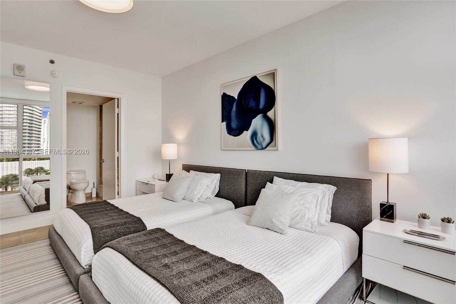 400 Alton Road, Unit 911 Miami Beach, FL 33139 - Photo 29 of 47 a bedroom with a bed and painting on the wall