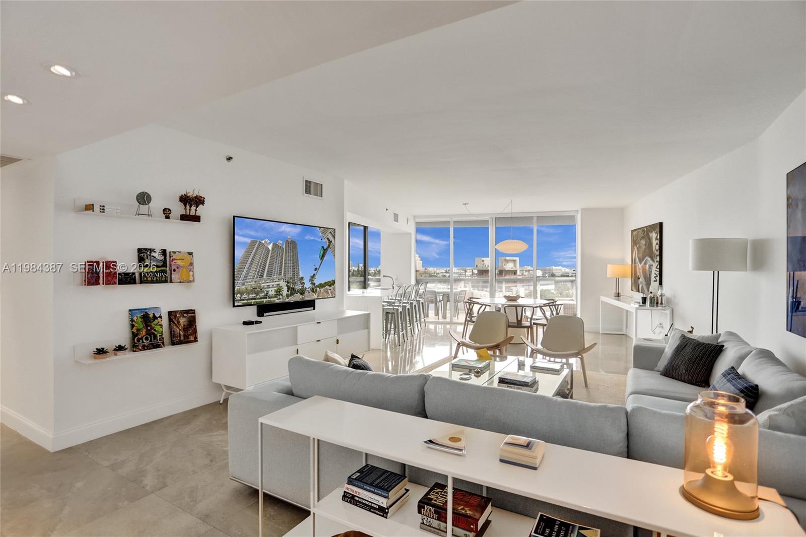 400 Alton Road, Unit 911 Miami Beach, FL 33139 - Photo 3 of 47 a living room with furniture and a flat screen tv