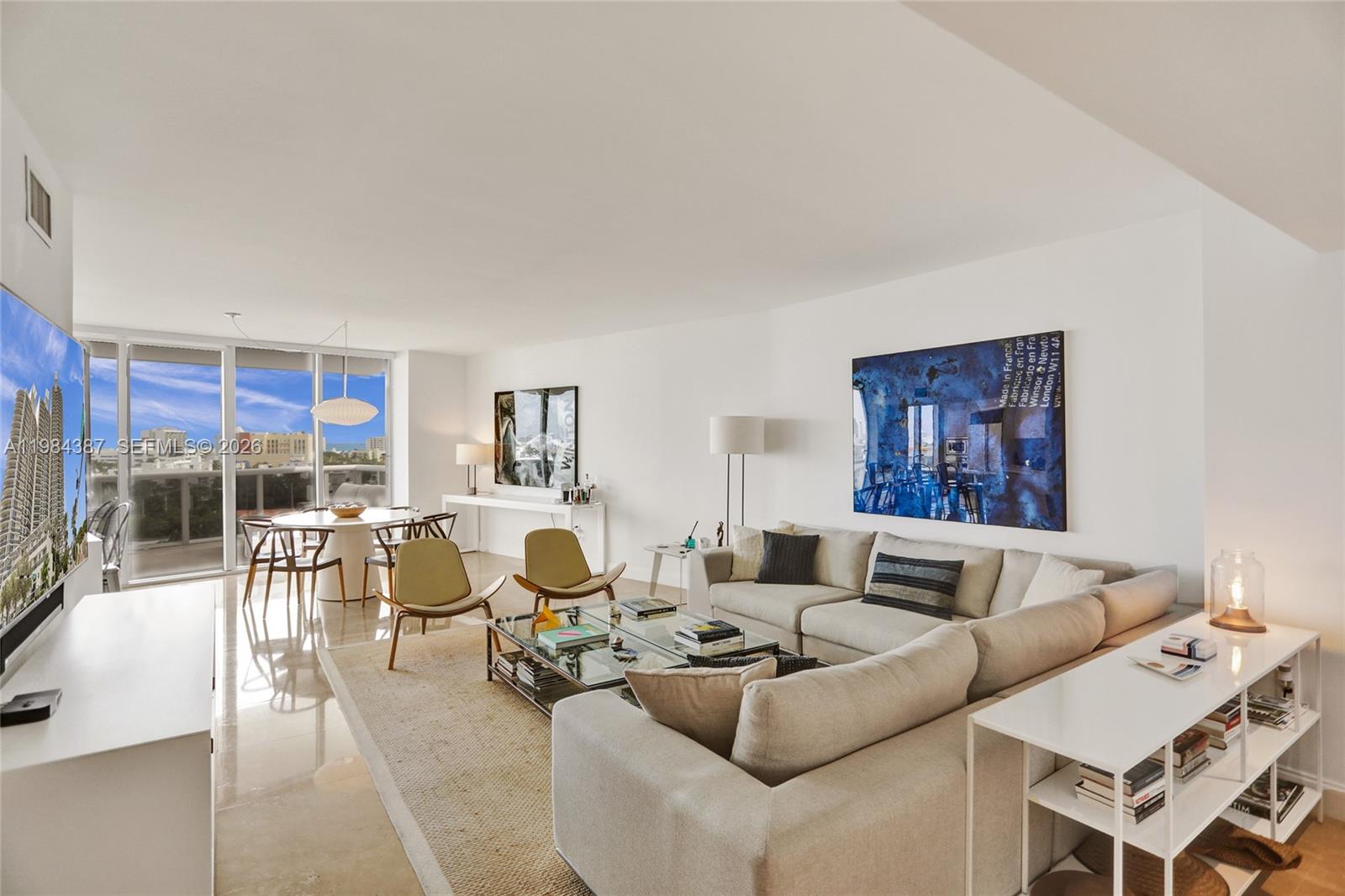 400 Alton Road, Unit 911 Miami Beach, FL 33139 - Photo 4 of 47 a living room with furniture and a flat screen tv
