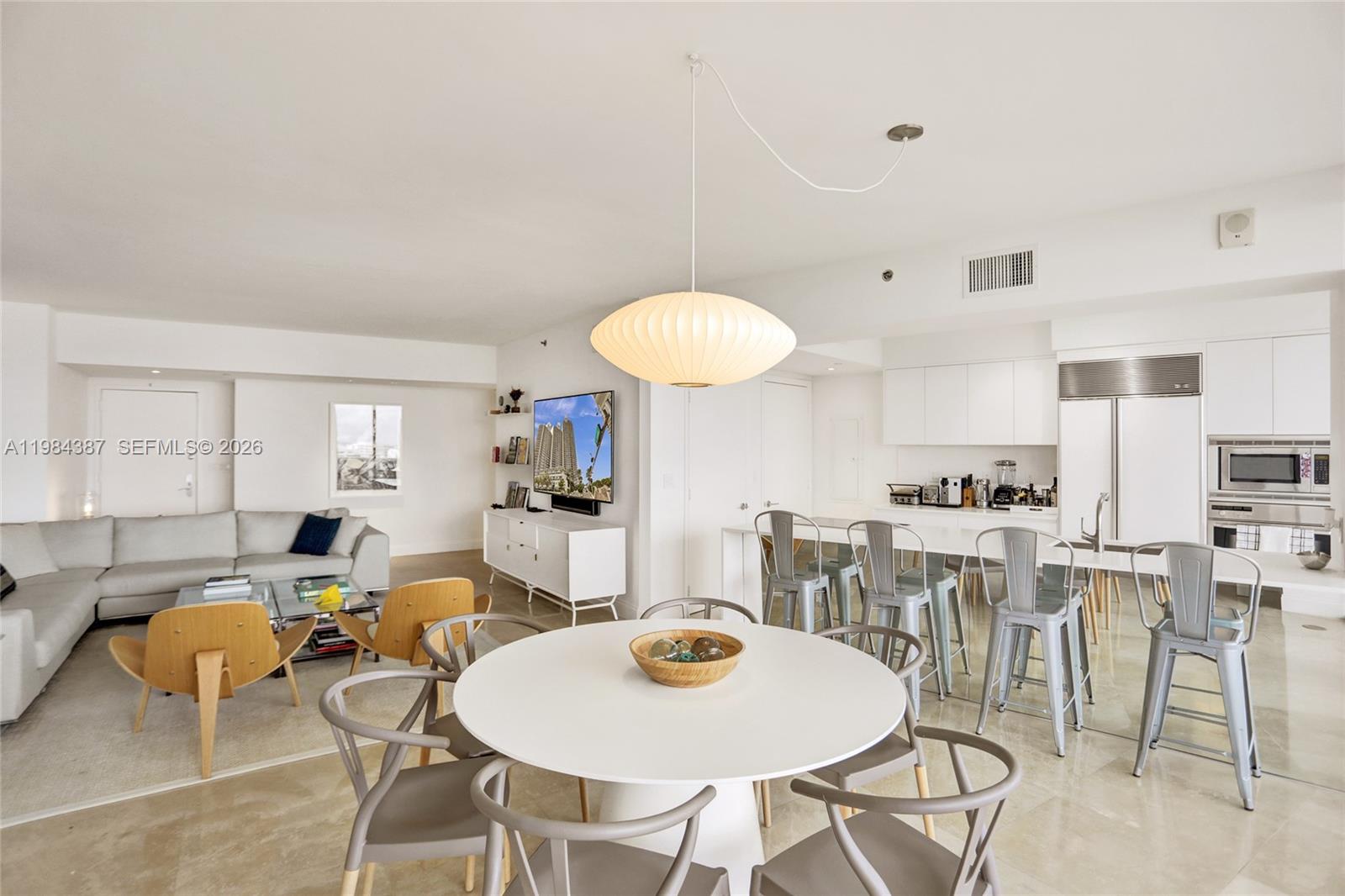 400 Alton Road, Unit 911 Miami Beach, FL 33139 - Photo 8 of 47 a living room with furniture a dining table and kitchen view