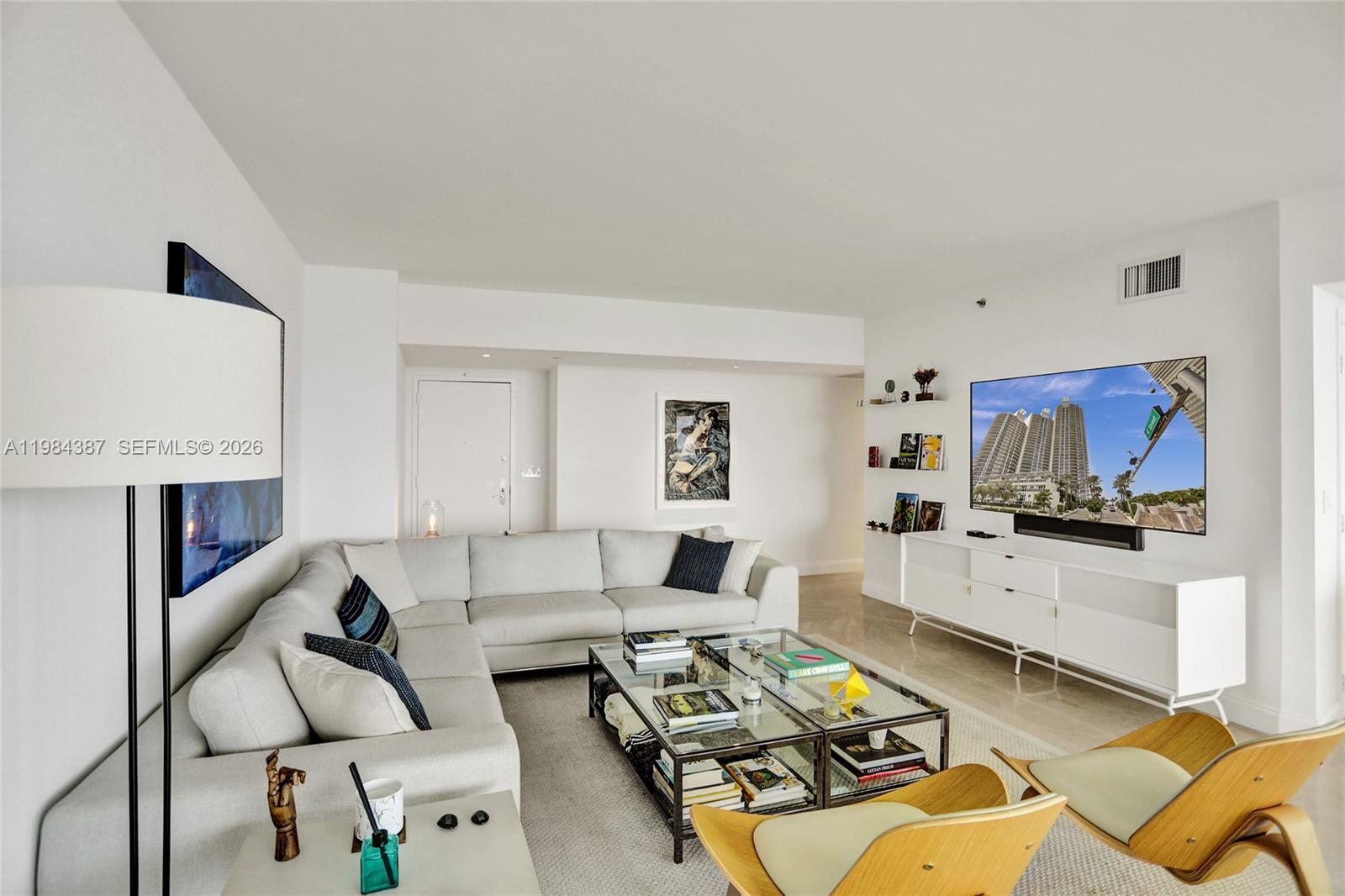 400 Alton Road, Unit 911 Miami Beach, FL 33139 - Photo 10 of 47 a living room with furniture a fireplace and a flat screen tv