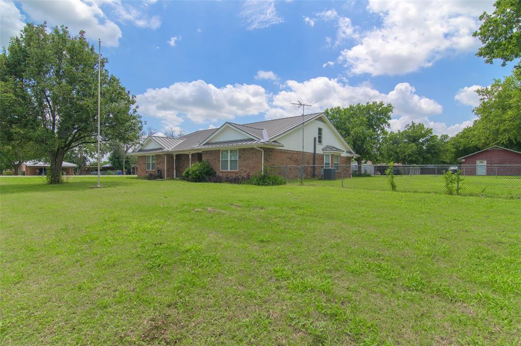 301 East 6th Street Krum, TX 76249 - Photo 25 of 29 Front and side view of this beautiful brick home and a large corner lot.