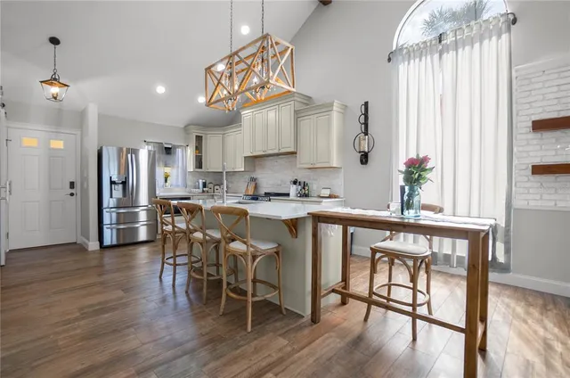 a kitchen with granite countertop a sink stainless steel appliances and cabinets
