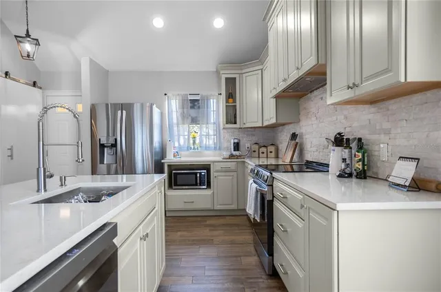 a view of a livingroom with wooden floor and a fireplace