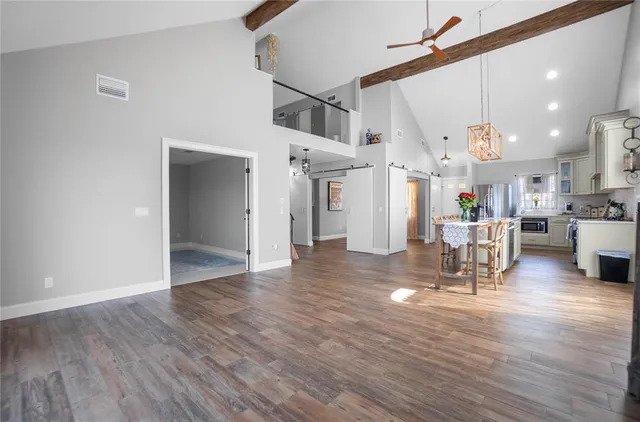 a very nice looking room with wooden floor and a window