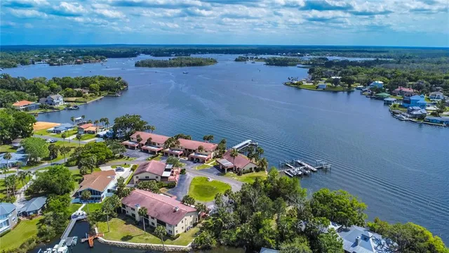 an aerial view of a houses with a lake view