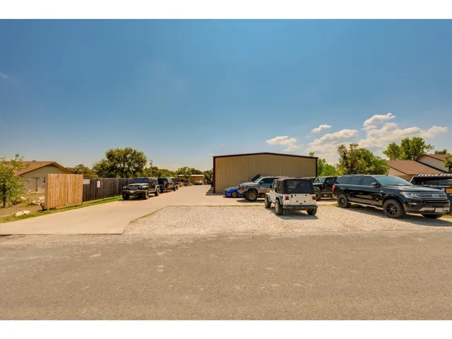 a car parked in front of a house with cars parked