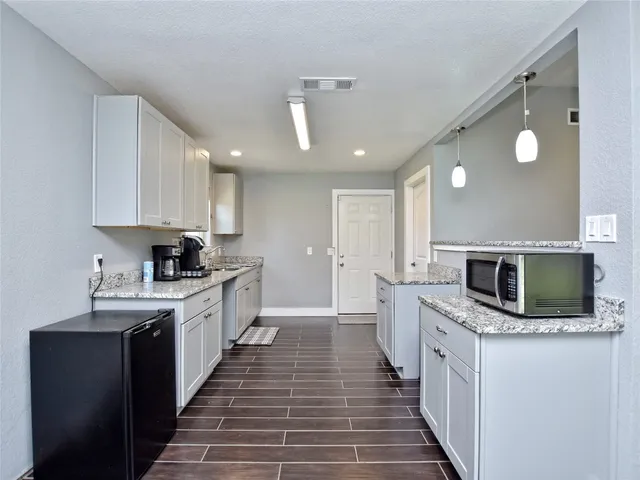 a kitchen with stainless steel appliances a microwave sink and cabinets