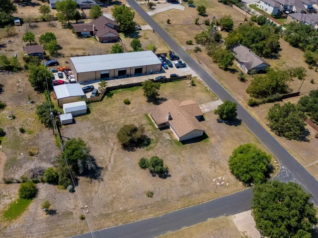 an aerial view of a house with a yard and pool