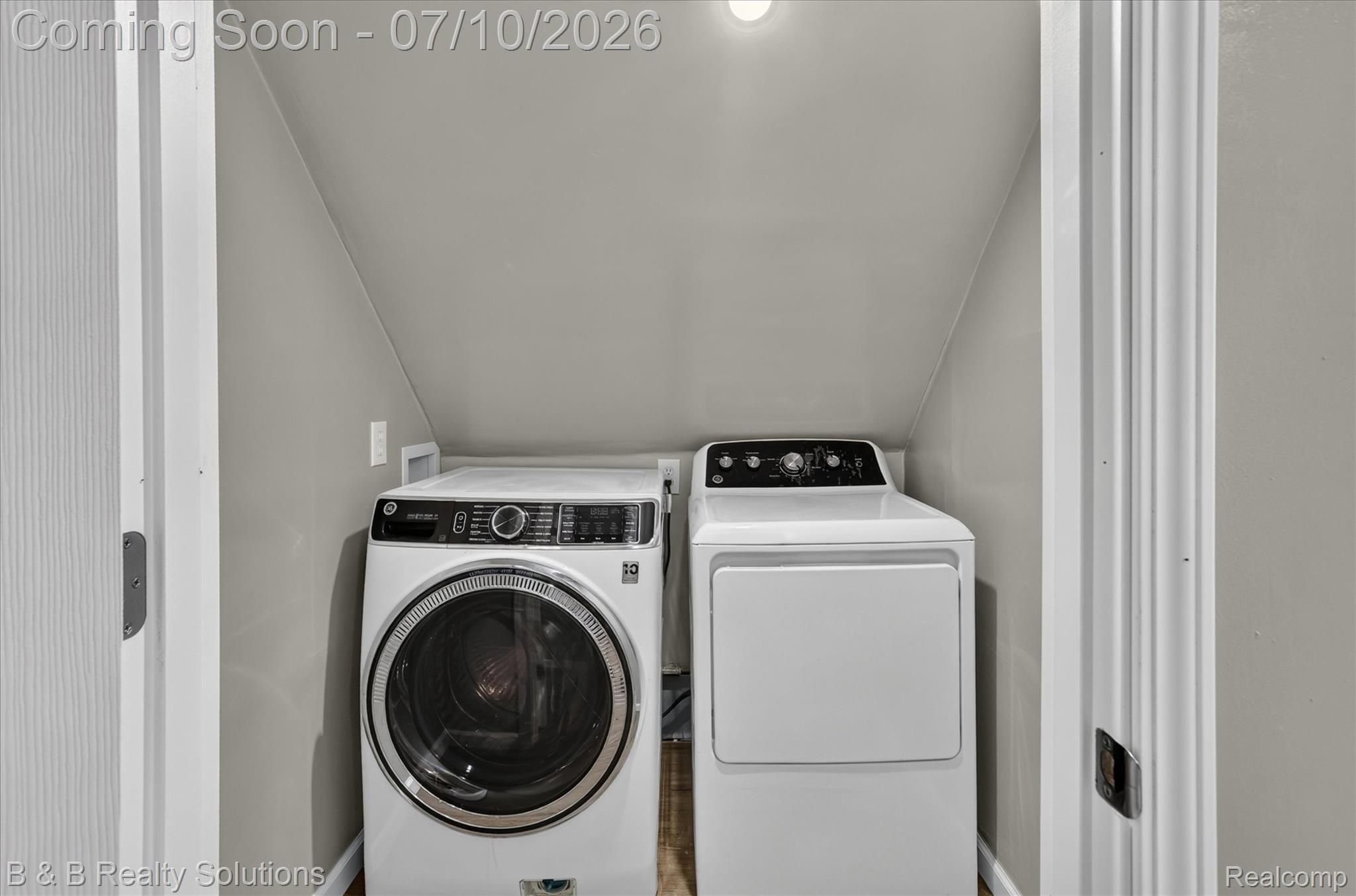 1564 East Burnside Road North Branch, MI 48461 - Photo 22 of 25 Dedicated laundry alcove featuring a front-loading washing machine, a top-loading dryer, and neutral gray walls