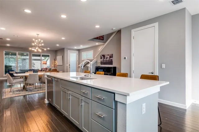 a kitchen with counter top space sink and center island