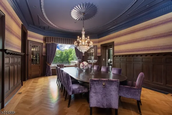 a dining room with furniture a chandelier and window
