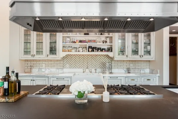 a kitchen with a sink a stove and a window