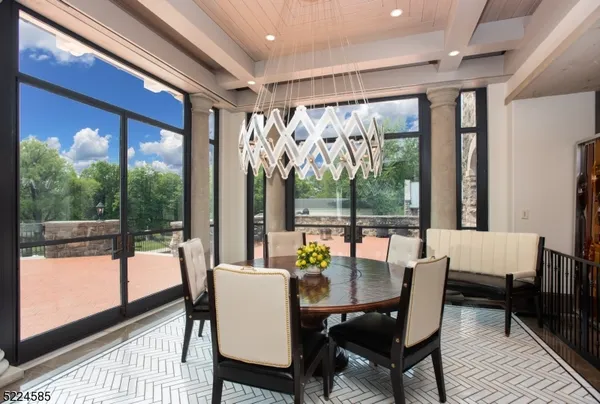 a view of a dining room with furniture large windows and wooden floor