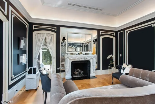 a living room with furniture fireplace and a large window