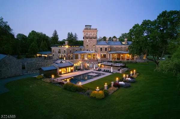 an aerial view of a house with swimming pool big yard and outdoor seating