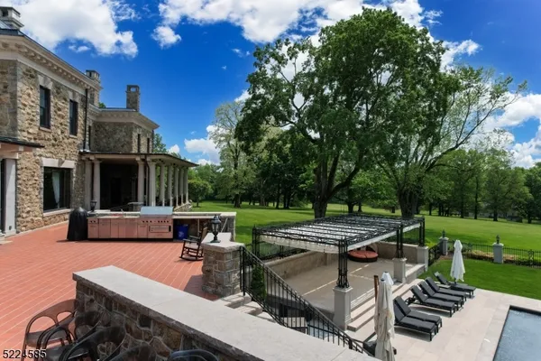 a outdoor space with a large tub and couches with wooden floor