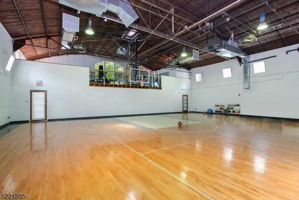 an aerial view of a house with a yard basket ball court and outdoor seating