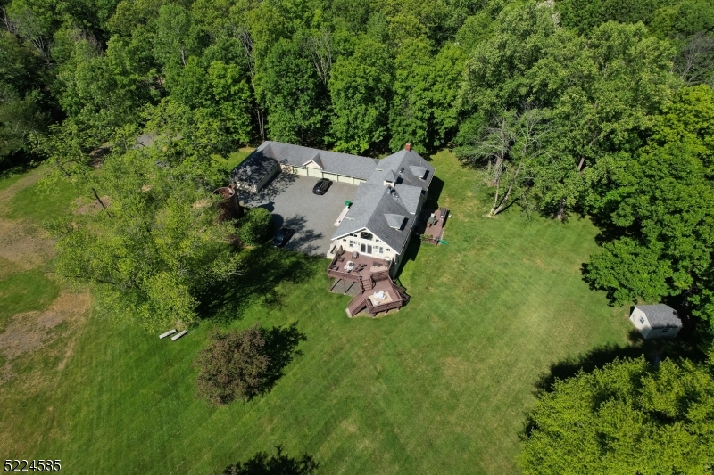 450 Claremont Road Bernardsville, NJ 07924 - Photo 45 of 47 an aerial view of a house with a yard basket ball court and trampoline