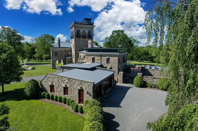 a aerial view of a house with a yard table and chairs