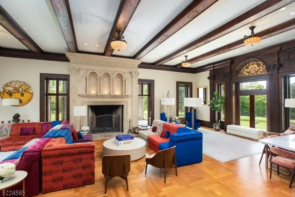 a living room with furniture fireplace and a large window