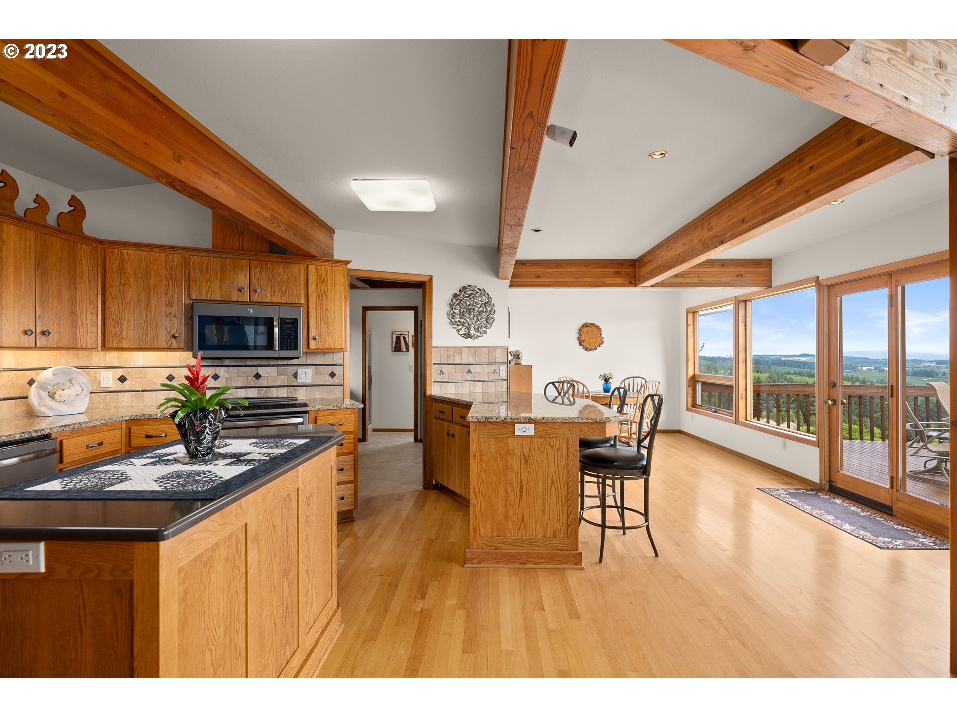 30875 Southwest Laurelview Road Hillsboro, OR 97123 - Photo 12 of 36 a dining hall with stainless steel appliances a stove a sink dishwasher with a dining table and chairs with wooden floor