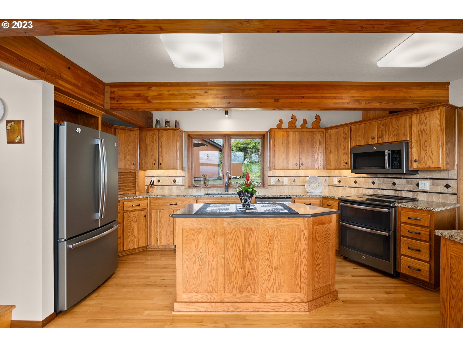30875 Southwest Laurelview Road Hillsboro, OR 97123 - Photo 16 of 36 a kitchen with stainless steel appliances granite countertop a refrigerator and a stove