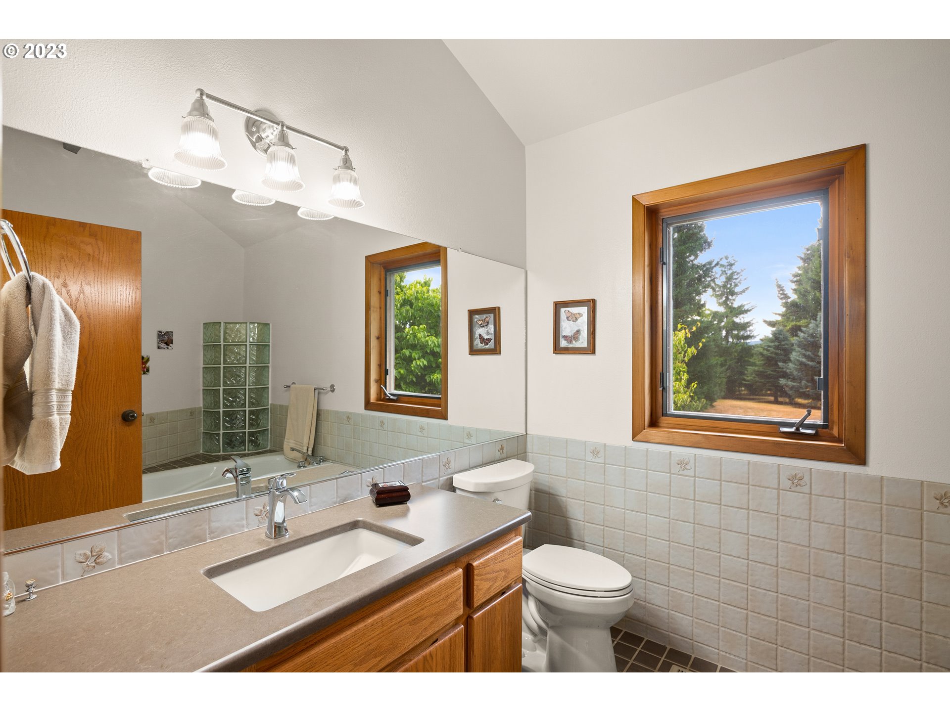30875 Southwest Laurelview Road Hillsboro, OR 97123 - Photo 27 of 36 a bathroom with a double vanity sink toilet and a mirror