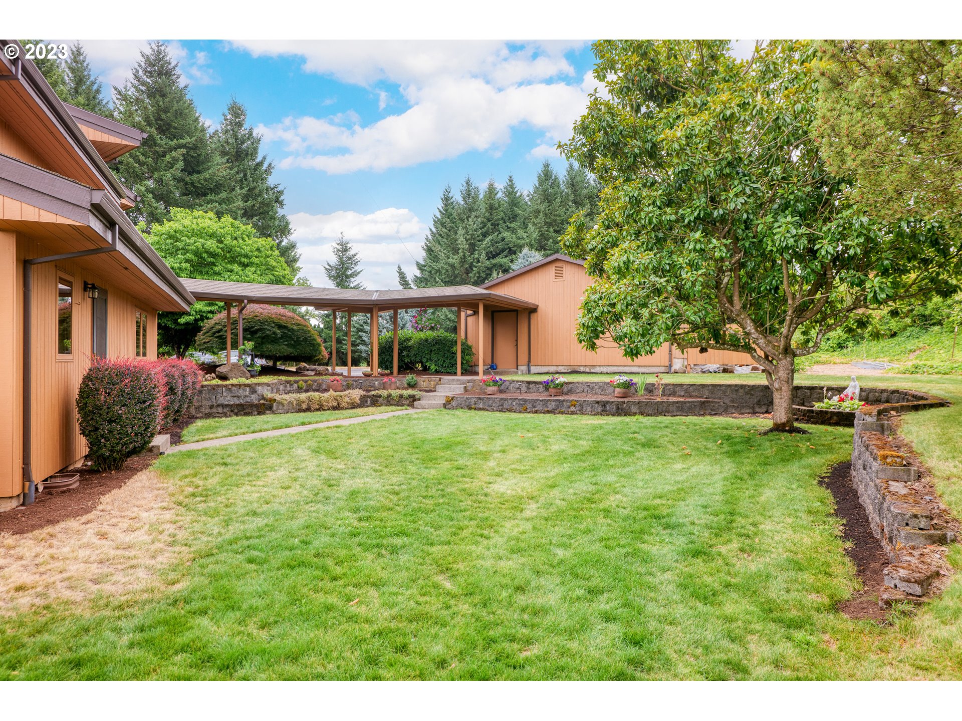 30875 Southwest Laurelview Road Hillsboro, OR 97123 - Photo 6 of 36 a view of a house with a backyard porch and sitting area